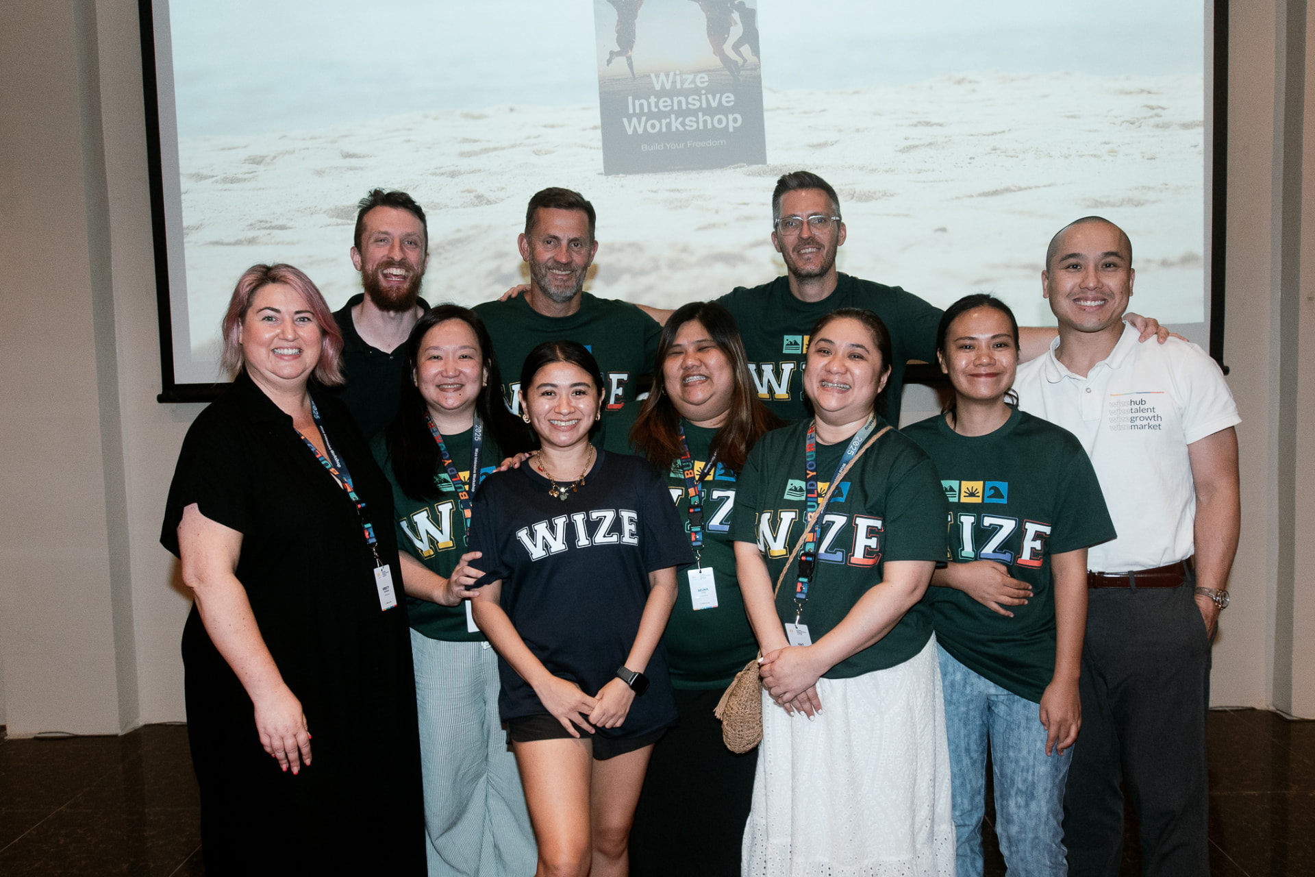 A workshop group smiling together in Wize shirts