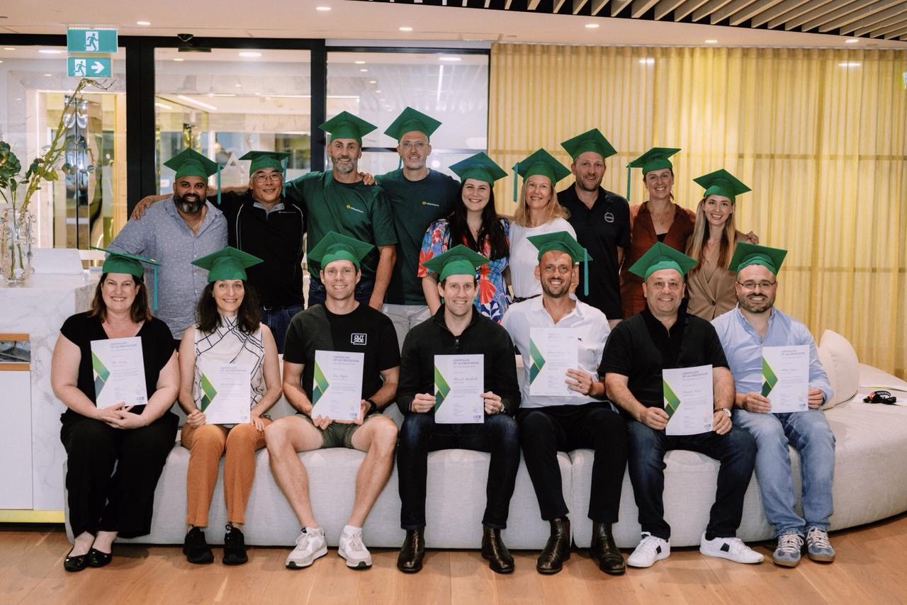 A graduating group holding certificates after an accredited program