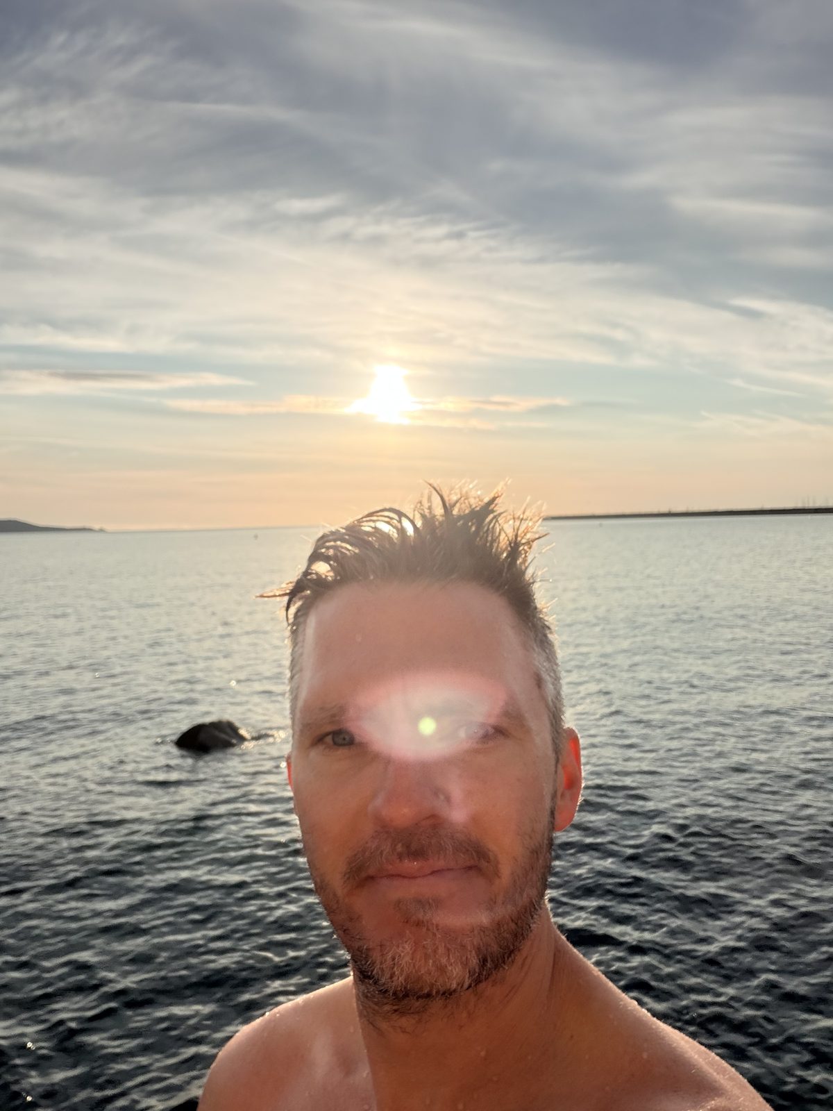 Bren in the sea at sunset after a swim