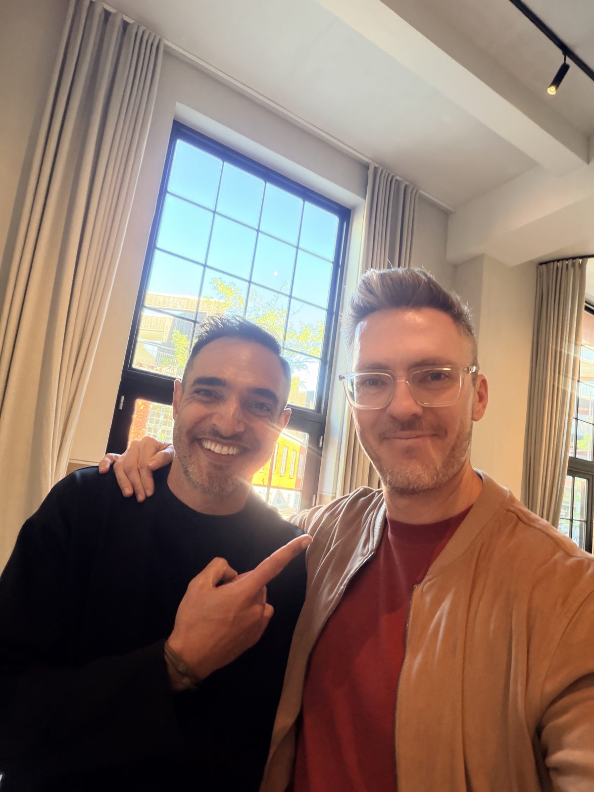 Bren with a friend, arm around his shoulder, both smiling
